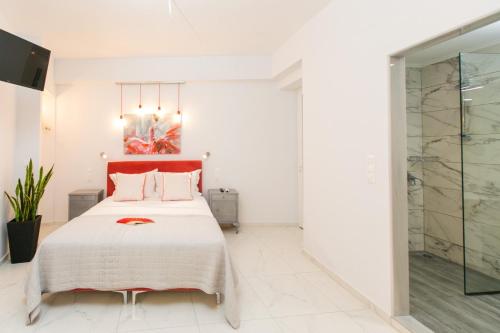 a bedroom with a bed and a glass shower at Apartments Barbie in Rethymno Town