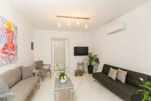 a living room with a couch and a tv at Apartments Barbie in Rethymno Town