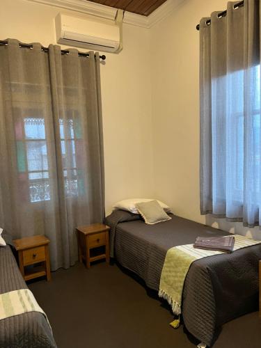 a bedroom with two beds and a window at Oriental Hotel Tumut in Tumut