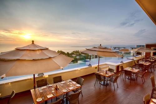 a view of a restaurant with tables and umbrellas at Marival Distinct All-Suites & World Spa - Handwritten Collection in Nuevo Vallarta 