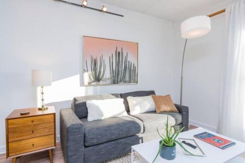 a living room with a couch and a table at Music Row Retreat with Pool and Free Parking, Walk to Bars! in Nashville