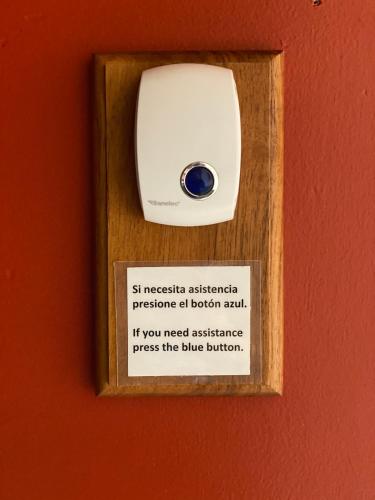 a sign in a wooden box on a wall at CASA SAUTO Family Suite next to the Cathedral in Mexico City