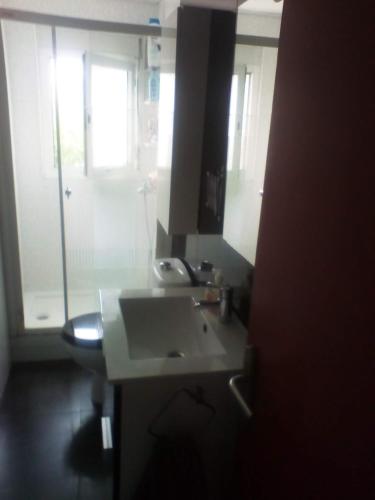 a bathroom with a sink and a toilet and a mirror at Bloque de Viviendas in Ibiza Town