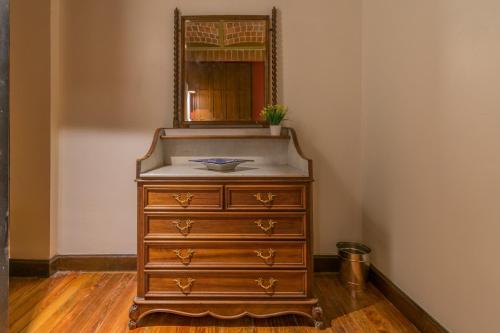 a dresser with a mirror on top of it at CASA SAUTO Family Suite next to the Cathedral in Mexico City