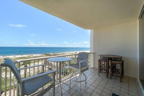 a balcony with a table and chairs and the beach at Beach Club C-509 in Gulf Highlands