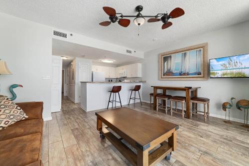 a living room with a couch and a table at Beach Club C-509 in Gulf Highlands