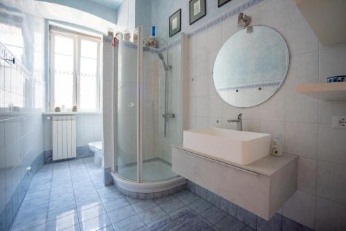 ein Bad mit einem Waschbecken, einer Dusche und einem Spiegel in der Unterkunft Art & History - NEW - Modern Classic Apartment in Triest