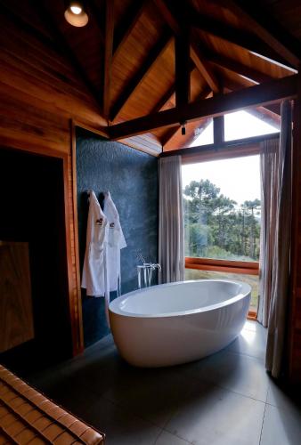 a large bath tub in a room with a window at Tenuta Bergamaschi in São Joaquim
