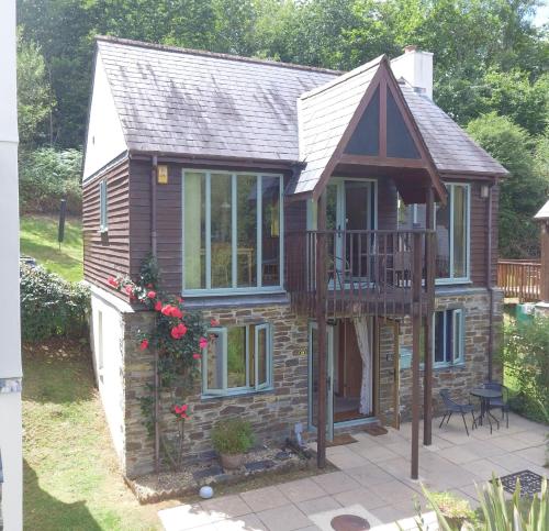 a tiny house with a balcony and a deck at The Nineteenth, Oakridge St Mellion, Free Golf/SPA in St. Mellion