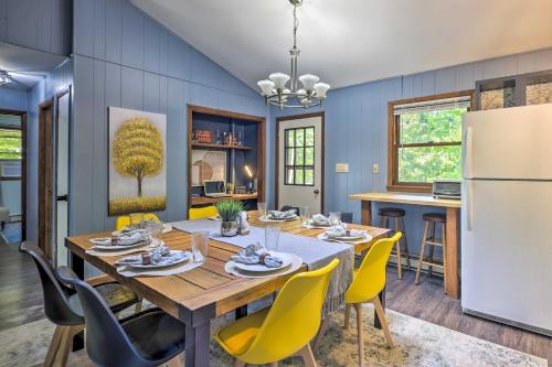 a kitchen and dining room with a table and yellow chairs at Wraparound Deck Big Bass Lake Home in Gouldsboro in Gouldsboro
