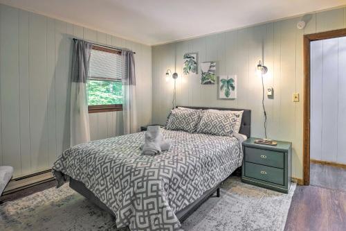 a bedroom with a bed and a window at Wraparound Deck Big Bass Lake Home in Gouldsboro in Gouldsboro