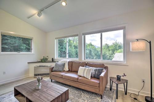 a living room with a couch and a table at Airy and Bright Hideaway Near Smugglers Notch! in Cambridge