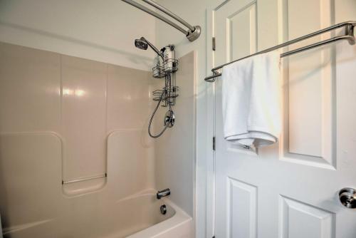 a white bathroom with a shower and a bath tub at Airy and Bright Hideaway Near Smugglers Notch! in Cambridge