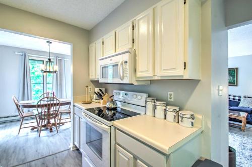 a kitchen with white cabinets and a stove top oven at Idyllic Wintergreen Condo with Resort Amenities in Mount Torry Furnace