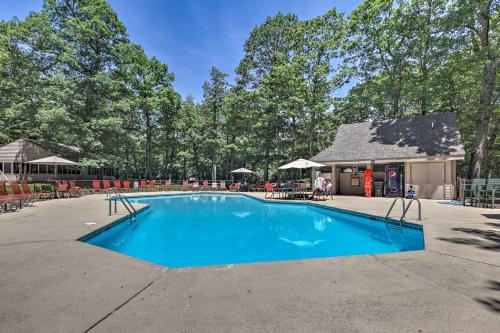 a swimming pool with chairs and a building at Idyllic Wintergreen Condo with Resort Amenities in Mount Torry Furnace
