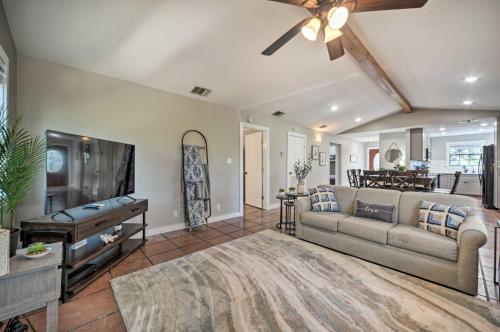 a living room with a couch and a flat screen tv at Canyon Lake Hideaway with Fire Pit and Yard! in Canyon Lake