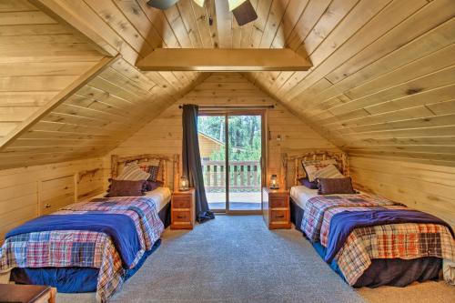 a bedroom with two beds in a log cabin at Deck, Porch and Grill Heber-Overgaard Getaway! in Heber
