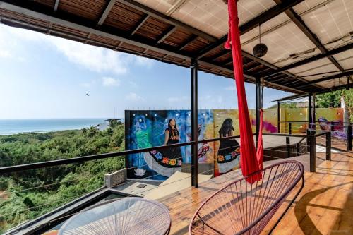 a balcony with two chairs and a view of the ocean at Cabane Container Hotel - ADULTS ONLY in Puerto Escondido