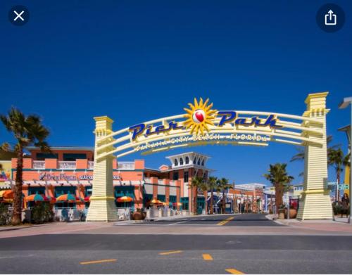 an entrance to a shopping center with a large sign at Beach Room, for wonderful Vacation in Panama City Beach