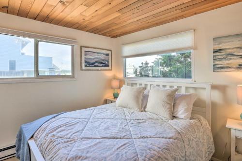 a bedroom with a large bed with two windows at Waterfront Ferndale Home Deck and Beach Access in Ferndale