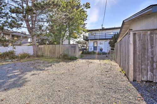 an empty driveway in front of a wooden fence at Waterfront Ferndale Home Deck and Beach Access in Ferndale