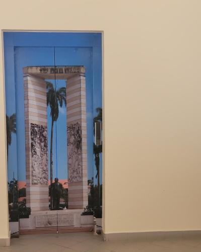a man is standing in front of a building at Hello Guyane(3), Suite Prestige Premium, 5 étoiles in Cayenne