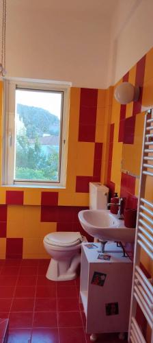 a colorful bathroom with a toilet and a sink at Popart Studio in Nafplio