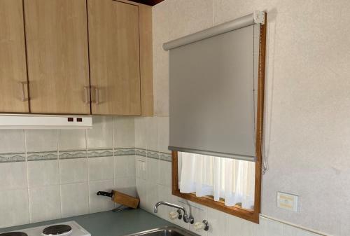 a kitchen with a sink and a window in it at Golden Country Motel and Caravan Park in Maryborough