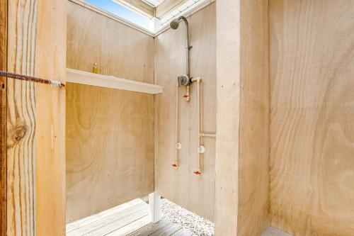 a shower in a room with wooden walls at Town of Bethany Beach - 114 Campbell Place in Bethany Beach