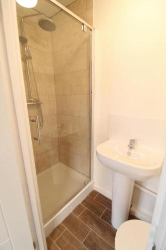 a bathroom with a shower and a sink and a toilet at Lovely studio flat in the heart of Holloway. in London