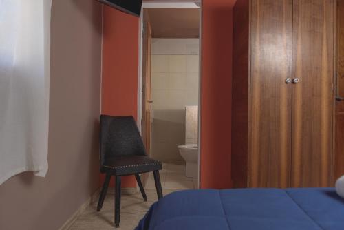 Ένα ή περισσότερα κρεβάτια σε δωμάτιο στο Hotel Nuevo Suizo
