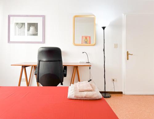a bedroom with a desk and a chair and a table at Nice cozy apartment in the mainland of Venice in Mestre