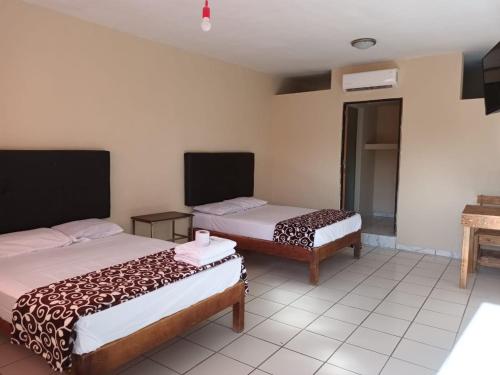 a room with two beds in a room at HOTEL MARIA TERESA in Río Verde