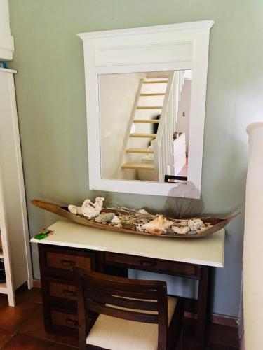 a mirror on top of a desk with a chair at bungalow 3116 vue sur piscine in Las Galeras