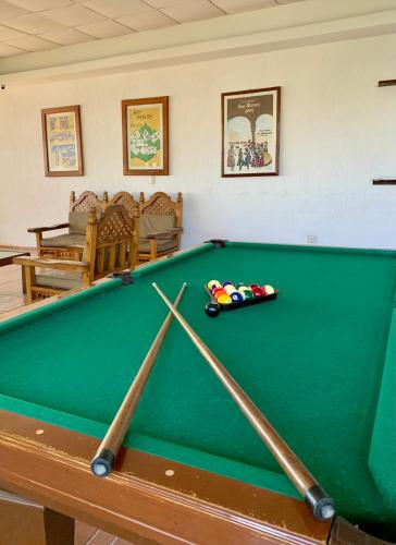 a green pool table with a toy car on it at Hotel Inn Galerias in Aguascalientes