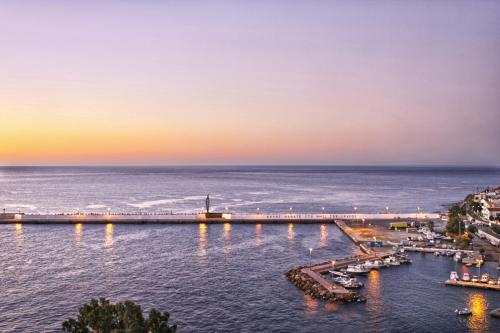 a view of a marina at sunset at Κastro Ηotel in Agios Kirykos