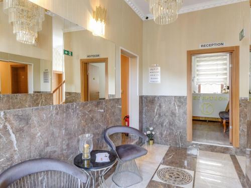 a room with two chairs and a table and a mirror at Apartment in city of Oberhausen Ruhr area in Oberhausen