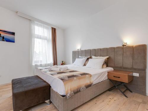 a bedroom with a large bed and a window at Deluxe Apartment in Oberhausen with Breakfast in Oberhausen
