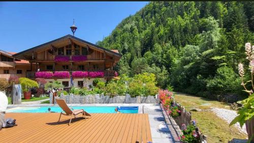 a house with a swimming pool next to a mountain at Ferienwohnungen Anni im Paradies in Kiefersfelden