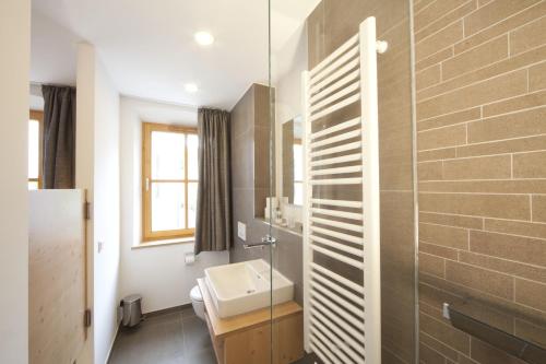 a bathroom with a sink and a glass wall at "beim Butz" in Wörth an der Donau