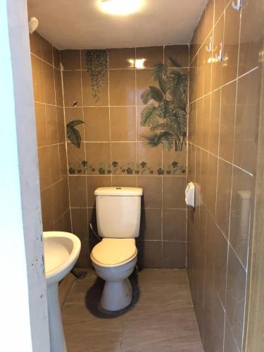 a bathroom with a toilet and a sink at RD Legend Hotel in Port Dickson