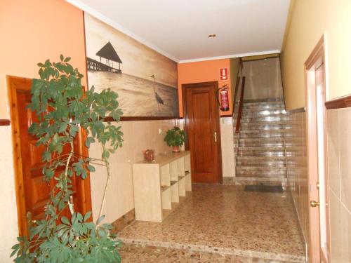 a hallway with a sink and a staircase in a house at Hostal Restaurante El Abuelo in Trobajo del Camino