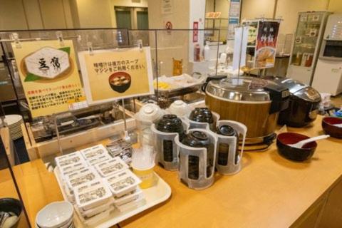 a counter in a kitchen with a bunch of food at AZ Inn Handa Inter in Handa