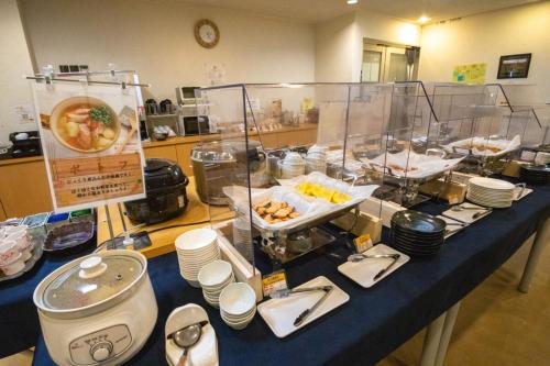 a buffet of food on a blue table at AZ Inn Handa Inter in Handa