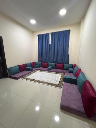 a living room with a couch in front of a window at Evan إيفان in Salalah