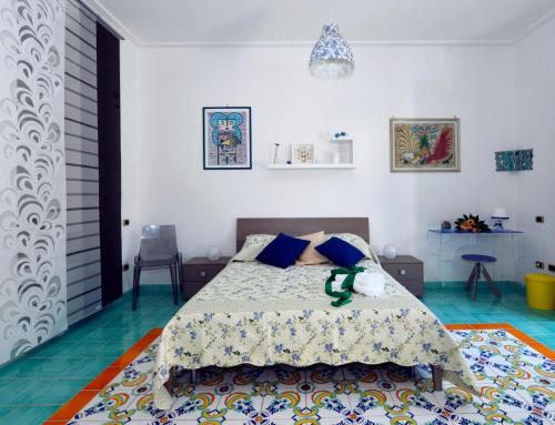 a bedroom with a bed with a colorful carpet at B&B Sognava in Salerno