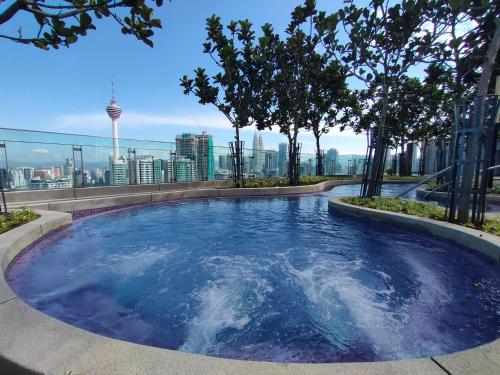 a hot tub on the roof of a building with trees at Eclipse Suites Robertson Bukit Bintang in Kuala Lumpur