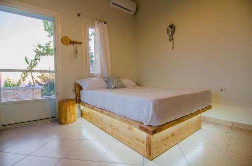 a bedroom with a bed in a room with a window at Ios stylish house Panoramic Sea and Sunset view in Ios Chora