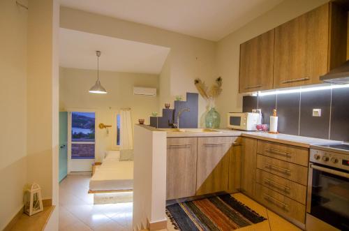 a kitchen with a sink and a stove top oven at Ios stylish house Panoramic Sea and Sunset view in Ios Chora