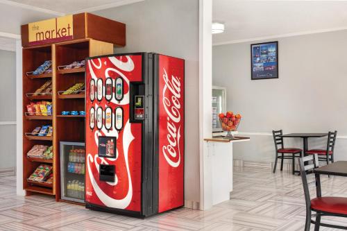 a coca cola vending machine in a room at Days Inn by Wyndham Kansas City International Airport in Kansas City